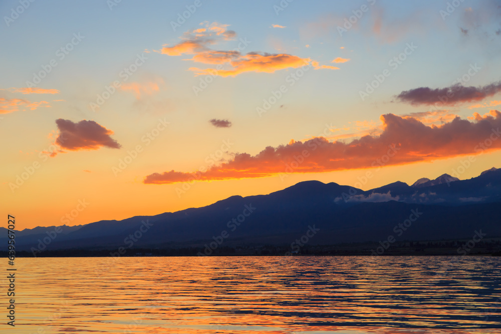 Colorful sea beach over mountains sunrise with deep blue sky and sunbeams. natural background