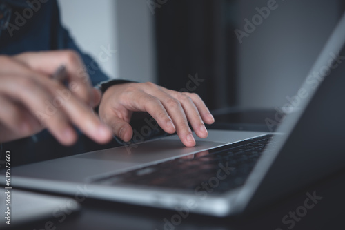 Business woman hands typing on laptop computer, surfing the internet, online working from home office with mobile phone, digital tablet on office table, close up
