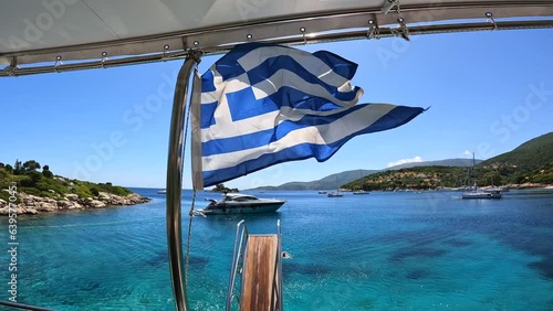 Greek flag on boat cruise around the island of Ithaki or Ithaca in the Ionian sea in the Mediterranean sea of Greece photo