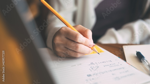 No face closeup hand young adult women writing note for study and work