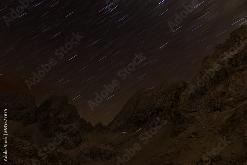 Star trails above alpine landscapes