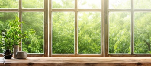 Nature glimpse. Sunlit window view with wooden table in old house. Vintage charm. Rustic serenity. Sunshine and greenery. Tranquil backdrop. Elegance in simplicity