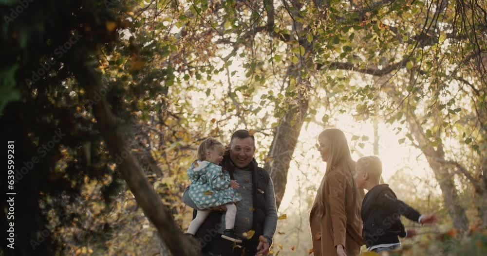Family with two children have fun in autumn park Family with two children have fun in autumn park