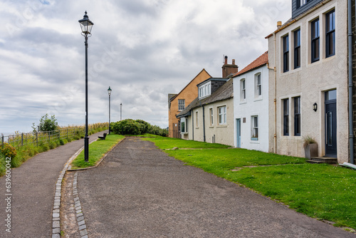 Street with houses by the sea in the medieval town of Saint Andrews in eastern Scotland. photo