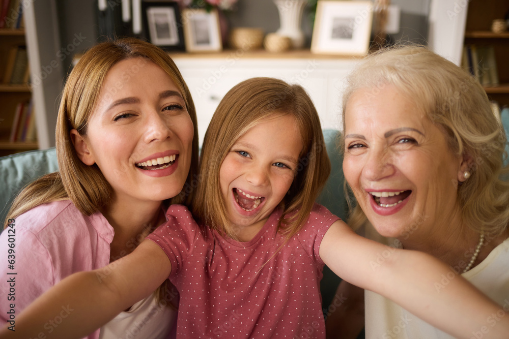 Happy grandmother, mother and granddaughter taking selfies at home Happy grandmother, mother and granddaughter taking selfies at home
