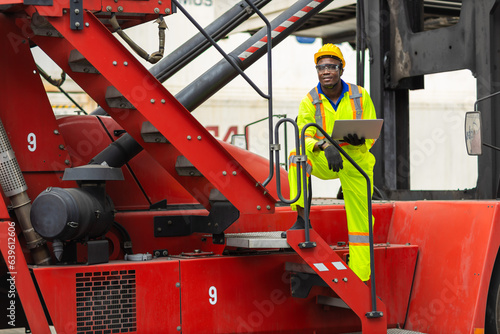 Φωτογραφία African male dock worker control loading containers cargo at warehouse container shipyard