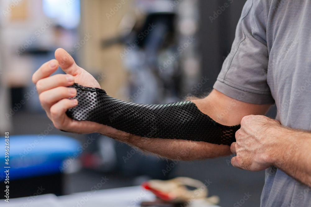 Medical brace on arm of man at physio Medical brace on arm of man at physio