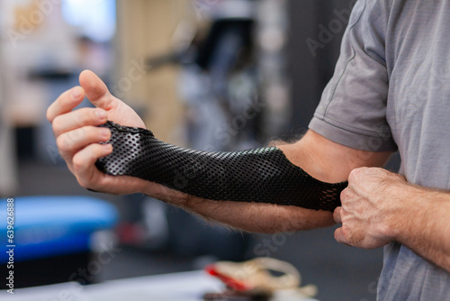 Medical brace on arm of man at physio