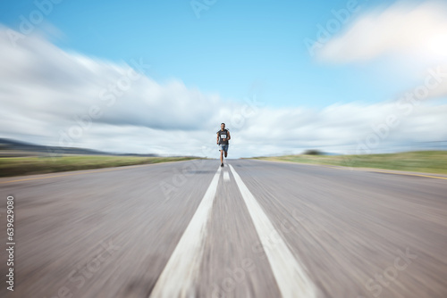 Fitness, energy and man runner in road for competition, running or workout in countryside. Sports, race and male athlete in street for training, exercise or speed, resilience or performance challenge © Azee Jacobs/peopleimages.com