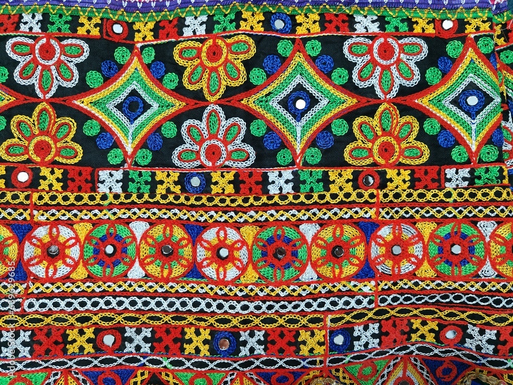 kanch kachhi work art. fabric hand work design on the traditional cloth. background. Indian art work of multicolor. Kuchhi bharat, hand craft with threads and niddle. kanch kachhi work art. fabric hand work design on the traditional cloth. background. Indian art work of multicolor. Kuchhi bharat, hand craft with threads and niddle.