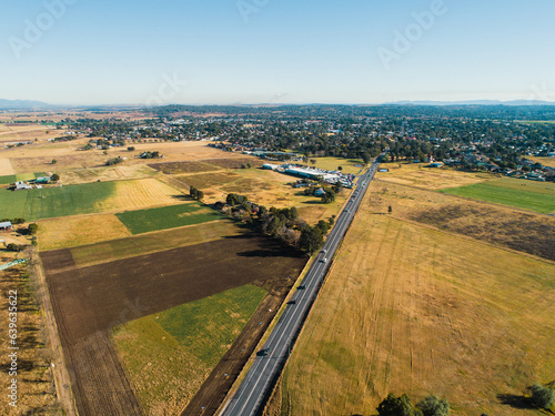 patchwork of farm paddocks beside highway