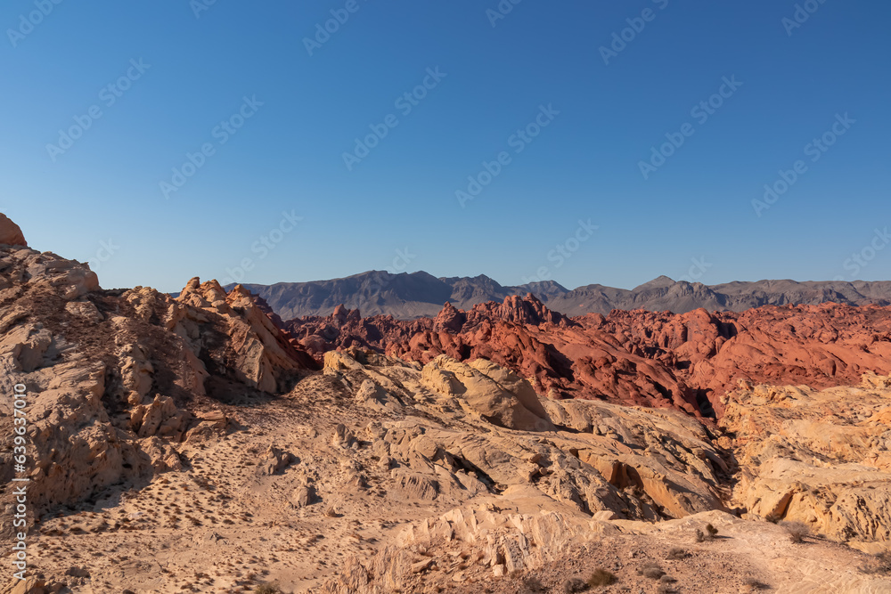 Scenic view of from Silica Dome viewpoint overlooking the Valley of Fire State Park in Mojave desert, Nevada, USA. Landscape of Aztek sandstone rock formations. Hot temperature in arid vegetation