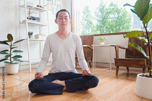 Meditation, zen asian man in relax, peace and mental health in house living room