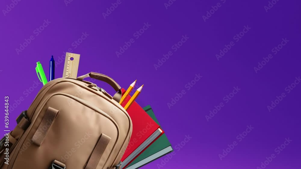 brown leather backpack with school supplies isolated on a grey ...