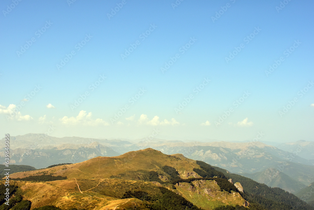 Summer day mountain landscape with blue sky and copy space for travel text.