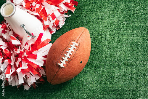Sports: Cheerleader Megaphone And Poms With Football photo