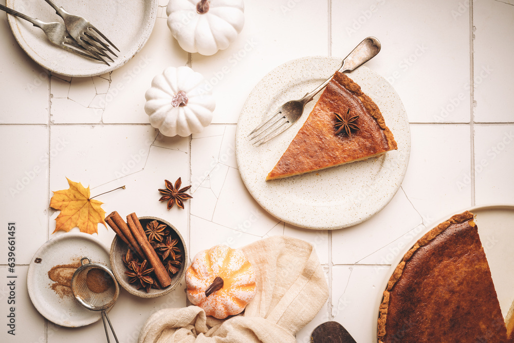 Piece of american pumpkin pie with cinnamon on white tile background, top view Piece of american pumpkin pie with cinnamon on white tile background, top view