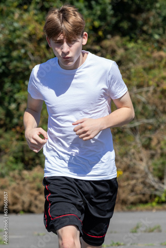 Teenage boy running during summer