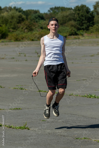 Teenage boy skipping with a skipping rope