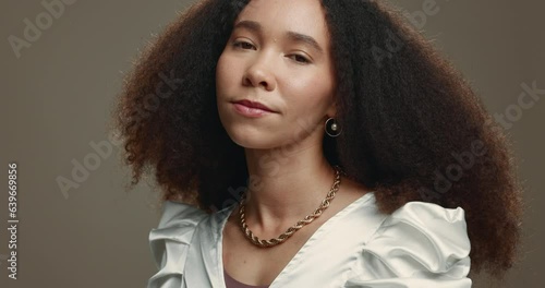 Face, hair and natural with an afro woman in studio on a gray background for salon treatment. Portrait, spa and beauty with a confident young female model at the hairdresser for haircare or hairstyle photo