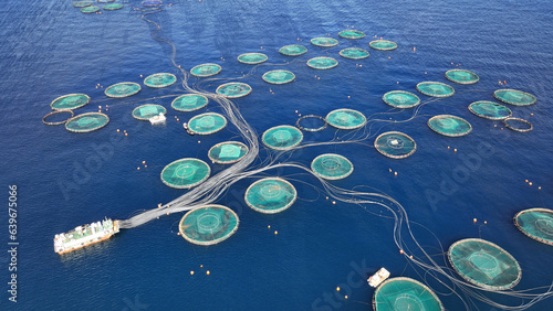Obraz na płótnie Aerial drone photo of latest technology fish farm breeding cages in fishery unit located in Mediterranean deep blue sea w salonie