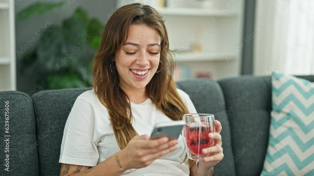 Young beautiful hispanic woman drinking tea using smartphone at home Young beautiful hispanic woman drinking tea using smartphone at home