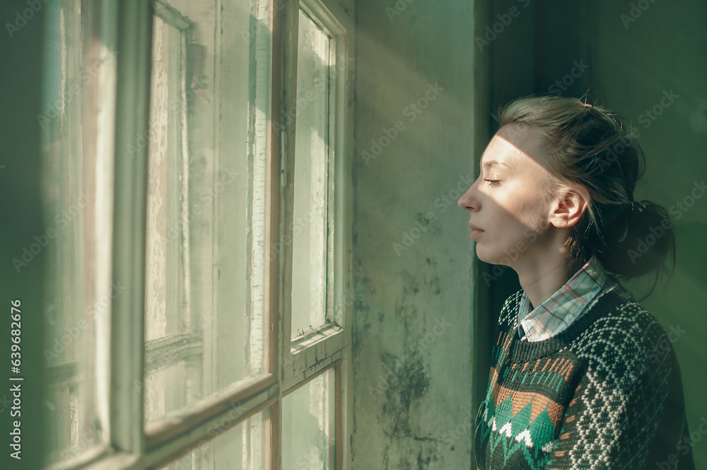 girl in front of the window in the sunlight girl in front of the window in the sunlight