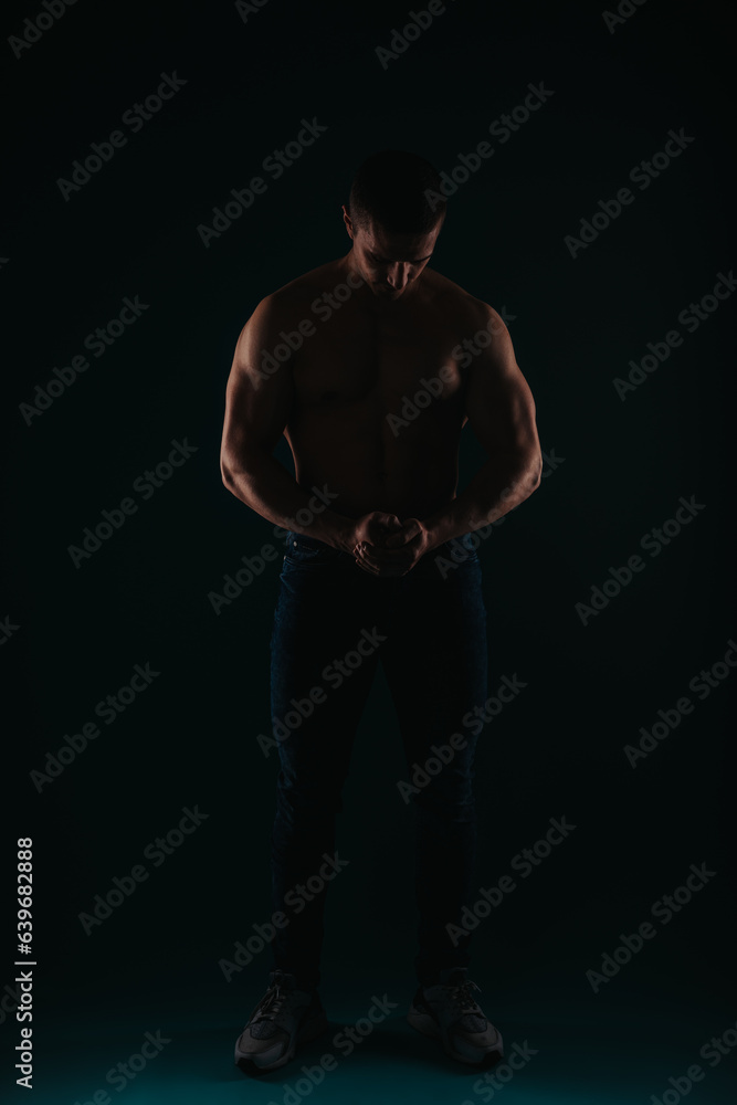 Fototapeta premium Charming and well-built man flexing his muscles