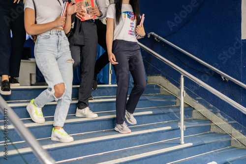 Partial shot of students walking downstairs at school while going home after their last class