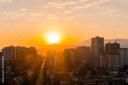 View of the breathtaking sunrise sky with the rising sun over the city of Batumi  Georgia. City is slowly awakening. Urban  early morning  summer and cityscape concept