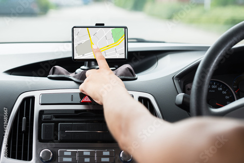 Fotografie Female's Hand Using GPS Navigation