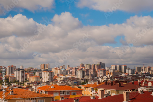 View of white clouds in the blue sky over typical turkish apartment, residential buildings in Istanbul - afternoon, cloudy, daylight. Cityscape, urban and architecture concept photo