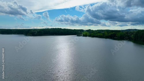 4K drone footage at lake Allatoona . White clouds over the lake in the afternoon. Green trees and calm waters. photo