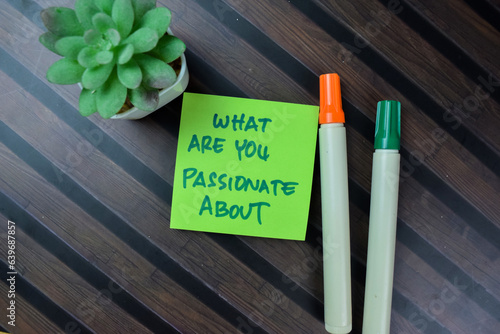 Concept of What Are You Passionate About write on sticky notes isolated on Wooden Table.