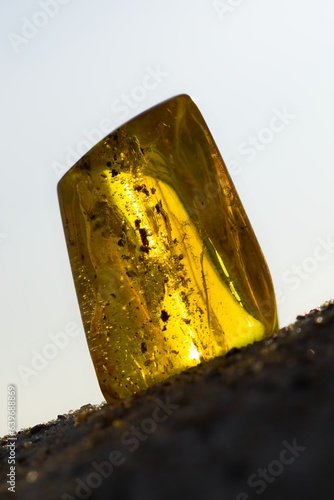 Natural, polished Baltic amber on a sandy beach in Kołobrzeg, Poland.