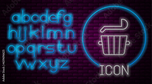 Glowing neon line Sauna bucket and ladle icon isolated on brick wall background. Neon light alphabet. Vector
