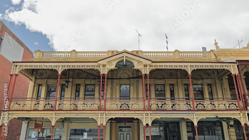Mid-Victorian heritage building from AD1872 with elaborate cast iron verandah and balustrade parapet, Lydiard Street. Ballarat-Ausralia-875+ photo