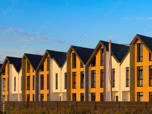 Newly built colorful townhouses built together as a single complex lined up in row in the suburbs for sale 
