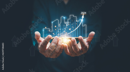 Concept of business prosperity and asset management, Real estate investment marketing analysis, Man holding graphic of analyzed graph of business growth, Planning to increase profits of business.