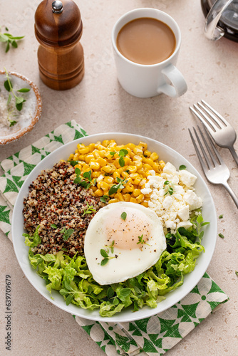 Breakfast bowl with quinoa, herbed corn, feta cheese and fried egg