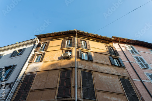 Wallpaper Mural Looking up at a slither of the Setting sun catching the top of ancient Italian apartment blocks in Rome, Italy Torontodigital.ca