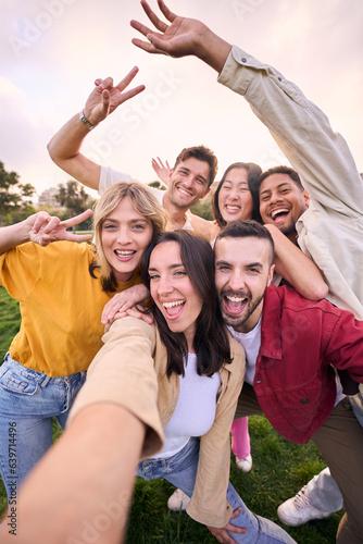 Vertical group young cheerful multi-ethnic friends taking selfie mobile phone outdoor. Happy people together smiling and enjoying free time in park. Positive and fun youth relationships in community. #639714496
