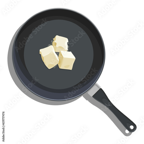 The frying pan is black with an elegant handle. Cubed butter melts slowly.