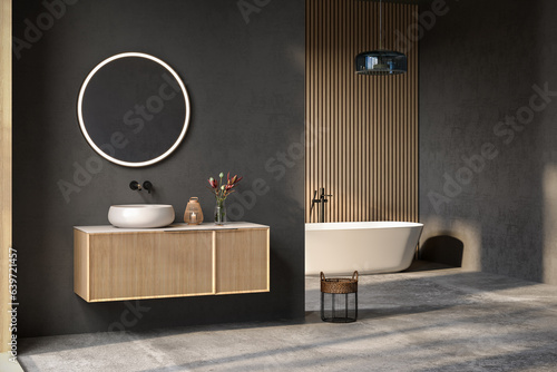 Fotobehang Comfortable bathtub and vanity with basin standing in modern bathroom black blue and wooden walls and concrete floor