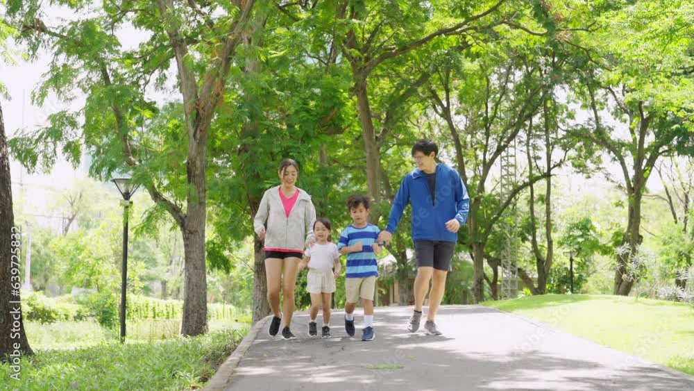 Happy Asian parent and little kids enjoy and fun outdoor lifestyle on summer vacation. Father, mother and child jogging workout exercise together at park. Family relationship and health care concept. Happy Asian parent and little kids enjoy and fun outdoor lifestyle on summer vacation. Father, mother and child jogging workout exercise together at park. Family relationship and health care concept.