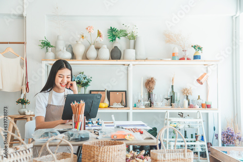 Small business owners are preparing a small shop and checking through a tablet and checking orders. photo