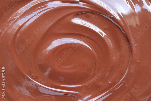 Melted delicious chocolate. Melted chocolate swirl background. Chocolate surface, melted premium chocolate swirl.