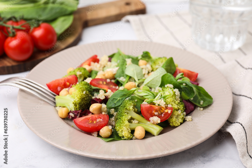 Healthy meal. Tasty salad with quinoa, chickpeas and vegetables served on table, closeup Healthy meal. Tasty salad with quinoa, chickpeas and vegetables served on table, closeup