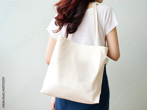 Wallpaper Mural Woman holding white blank tote bag for mockup template. Design tote bag mock-up, print presentation mock-up. AI generated. Torontodigital.ca