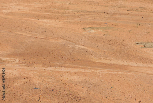 Beach sand, beautiful dark background. Desert landscape with red ground.
